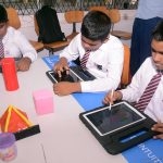 Students received Computer Tablets from the government.  This photo shows, students in a school in suburban Colombo, examining the Tablets.