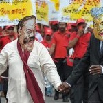 Dressed as Mahinda Rajapaksa and Ranil Wickremasinghe, two people participate in a JVP protest in 2013