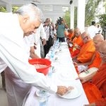 Prime Minister Ranil Wickremsinghe serving food to Buddhist priests recently. But former President Mahinda Rajapaksa is still the pre-eminent Sinhala Buddhist leader.