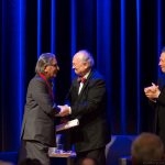 Balkrishna Doshi, was selected  as the 2018 Pritzker Architecture Prize Laureate .Here he is being congratulated by Glenn  Murcutt, Chairman of the Jury, while  Tom Pritzker, Chairman of the Hyatt Foundation which sponsors the prize and Martha Thorne, Executive Director of the Jury look on. The award ceremony took place at the Agha Khan Museum, Toronto in May this year.