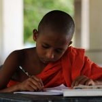 A student monk busy studying.  Temple’s are a rich source of ancient books and oral traditions where stories are told and re-told.