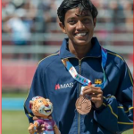 Paarami displays the medal she won.