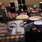 Bridal dressers puts make up on a Chinese bride’s face for the mass wedding ceremony for fifty Chinese couples in Colombo