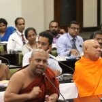 Some sections of the clergy as well as society are divided on whether or not SRH should be introduced to students. Prof. Medagoda Abhayatissa Thero (left),  Department of Pali & Buddhist Studies, University of Sri Jayawardenapura opposes the introduction of the Hathe Ape Potha to students, while Dr. Akuretiya Nanda Thero,(right), Chief Sanganayake of the Western Province, and Chancellor of the University of Ruhuna supports it. (Courtesy Parliament Media)